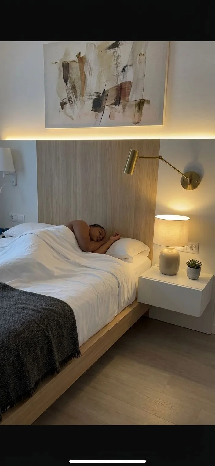Minimalist modern bedroom with light wood platform bed, white linen bedding, floating nightstand, brass sconce, abstract art, photorealistic interior design photography, 8k